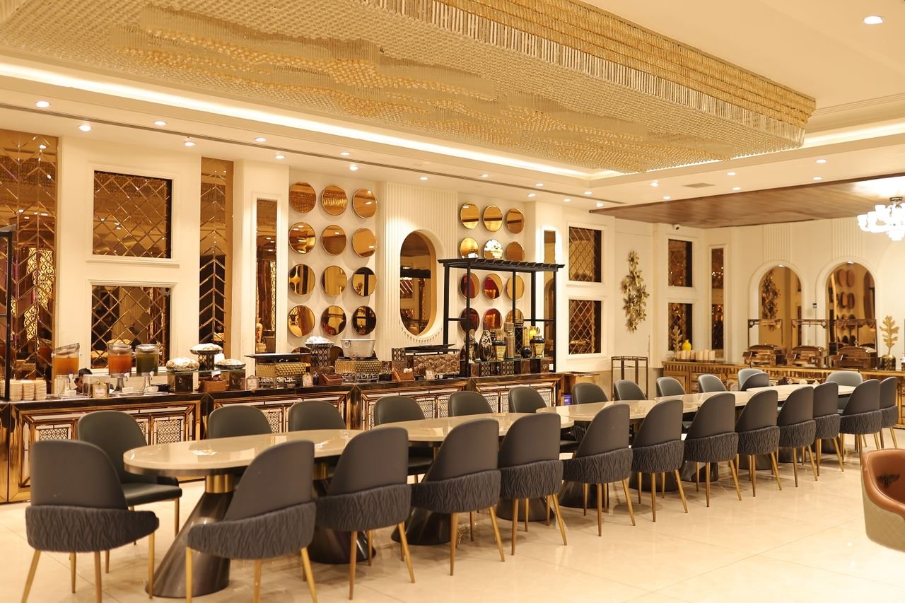 Elegant hotel restaurant dining area with modern seating and warm lighting